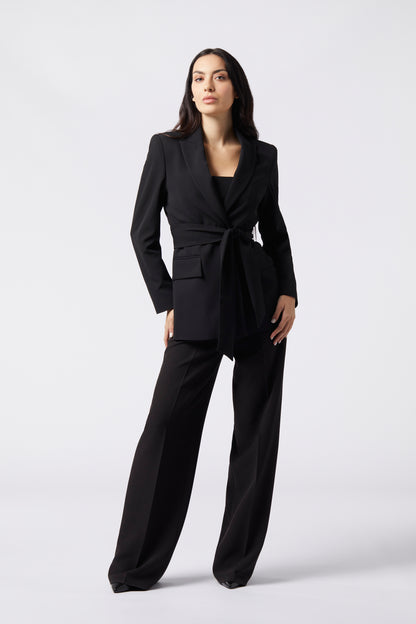 Tailleur Giacca con Cintura e Pantalone Palazzo
Elegante e raffinato, il nostro tailleur in tessuto tecnico è la scelta perfetta per chi desidera un look sofisticato in occasioni speciali come eventi, cerimonie, serate e lauree. La giacca doppiopetto avvitata con petto a lancia esalta la silhouette, mentre la cintura tono su tono dello stesso tessuto dona un tocco di femminilità e definizione. Il pantalone palazzo con gamba dritta completa il look, offrendo un’aria di classe e comfort senza compromessi.&nbs